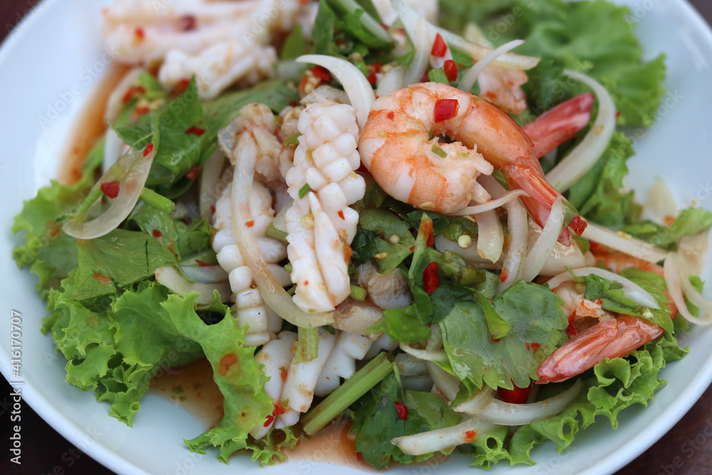 Thai Spicy Seafood Salad with shrimp,squid,fish,onion and lettuce. Delicious spicy Thai seafood. Thai Spicy Seafood Salad with shrimp,squid,fish,onion and lettuce. Delicious spicy Thai seafood.