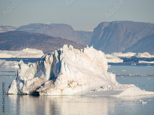 Iceberg in the Uummannaq Fjord System. Glaciated Nuussuaq peninsula in the background. Greenland, Denmark.