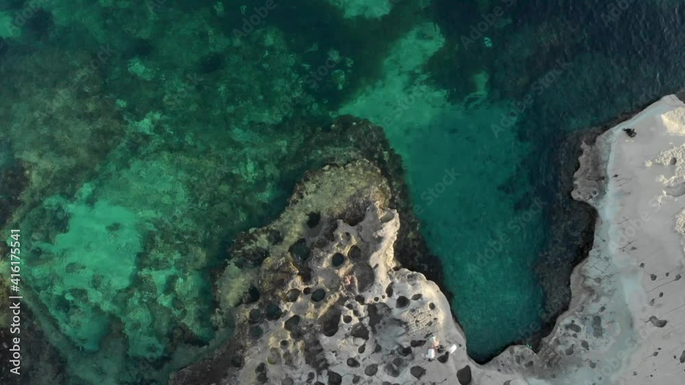 Establishing shot top down aerial view of the crystal blue waters of St Peter's Pool, Malta Establishing shot top down aerial view of the crystal blue waters of St Peter's Pool, Malta
