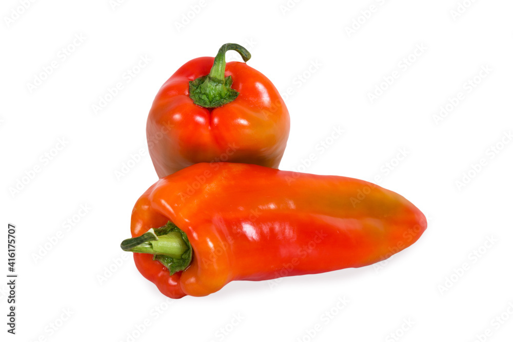 Two bulgarian sweet bell peppers on white wooden background.