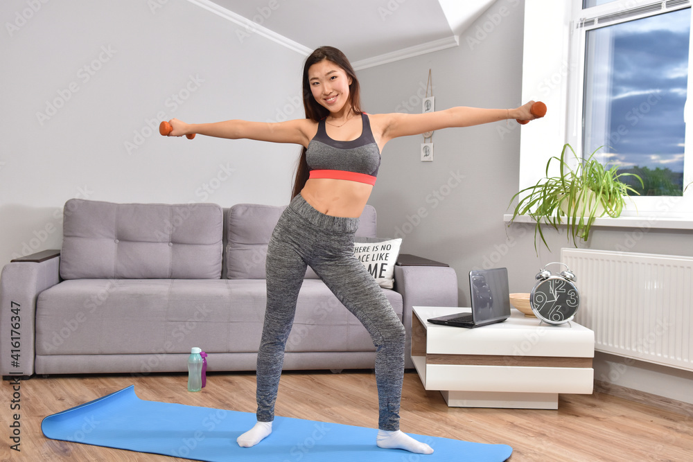 Asian woman making home workout with dumbbells Asian woman making home workout with dumbbells