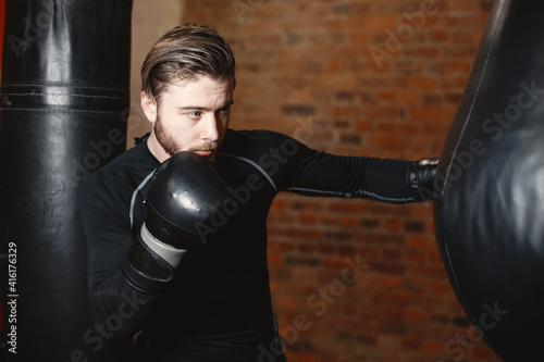 Sporty man boxing. Photo of boxer on a ring. Strength and motivation © prostooleh