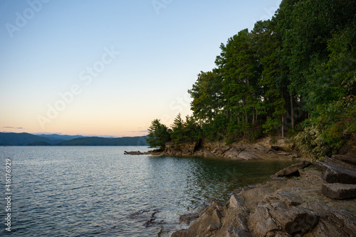 A rocky shoreline at Lake Jocassee, SC at sunset photo