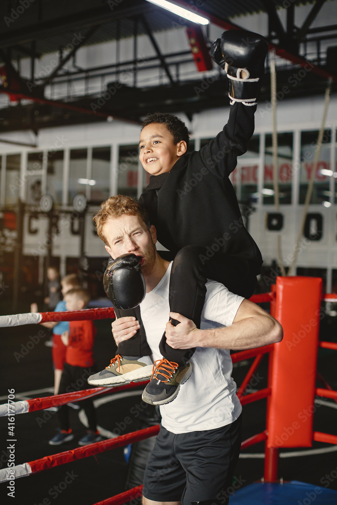 Young hardworking boxer learning to box. Child at sport center. Kid taking up a new hobby Young hardworking boxer learning to box. Child at sport center. Kid taking up a new hobby