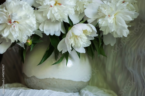 Fototapeta Naklejka Na Ścianę i Meble -  White peonies in cream pitcher