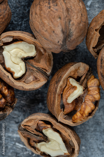 Half cut organic walnuts on marble background