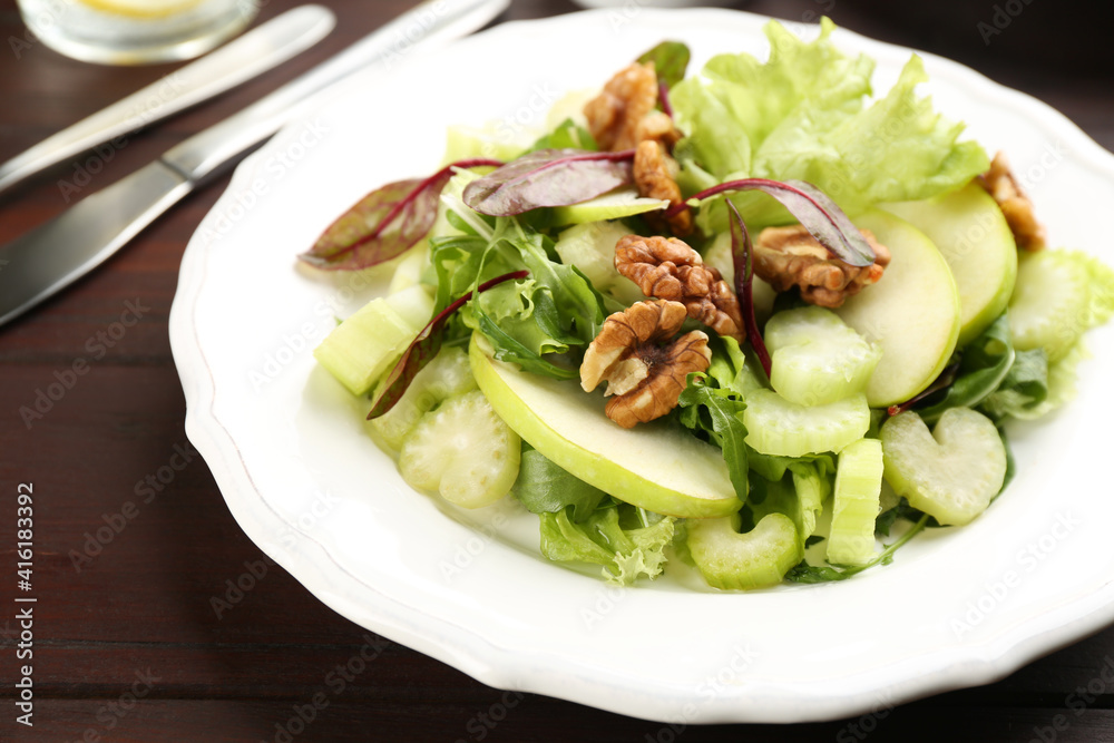 Delicious fresh celery salad on wooden table, closeup Delicious fresh celery salad on wooden table, closeup