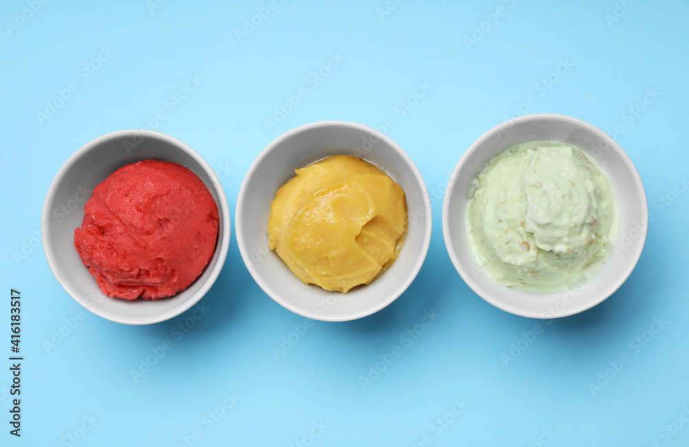 Different delicious ice creams on light blue background, flat lay Different delicious ice creams on light blue background, flat lay