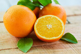 Orange fruits with leaf on wooden background, fresh orange slice and leaves healthy fruits