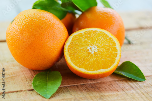 Orange fruits with leaf on wooden background, fresh orange slice and leaves healthy fruits