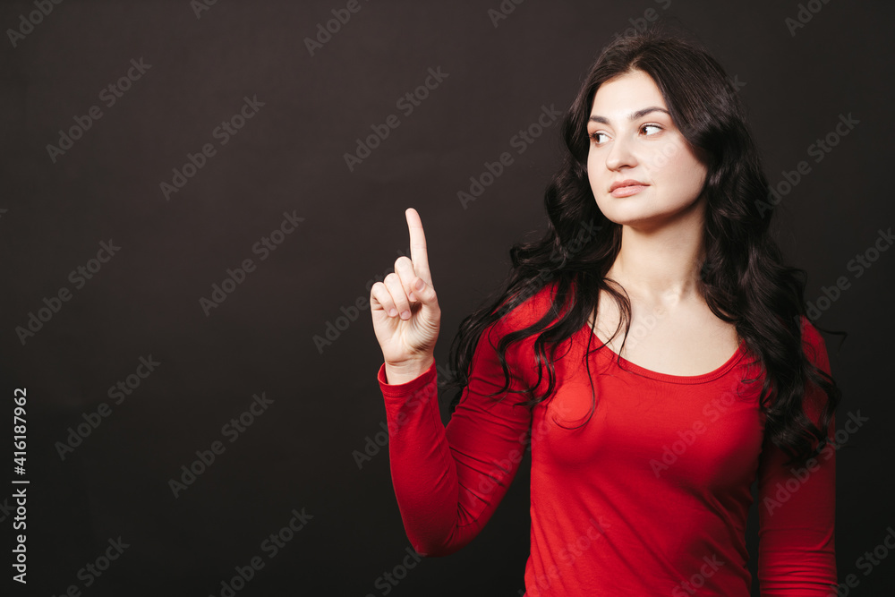 Woman pointing at free space for advertisement