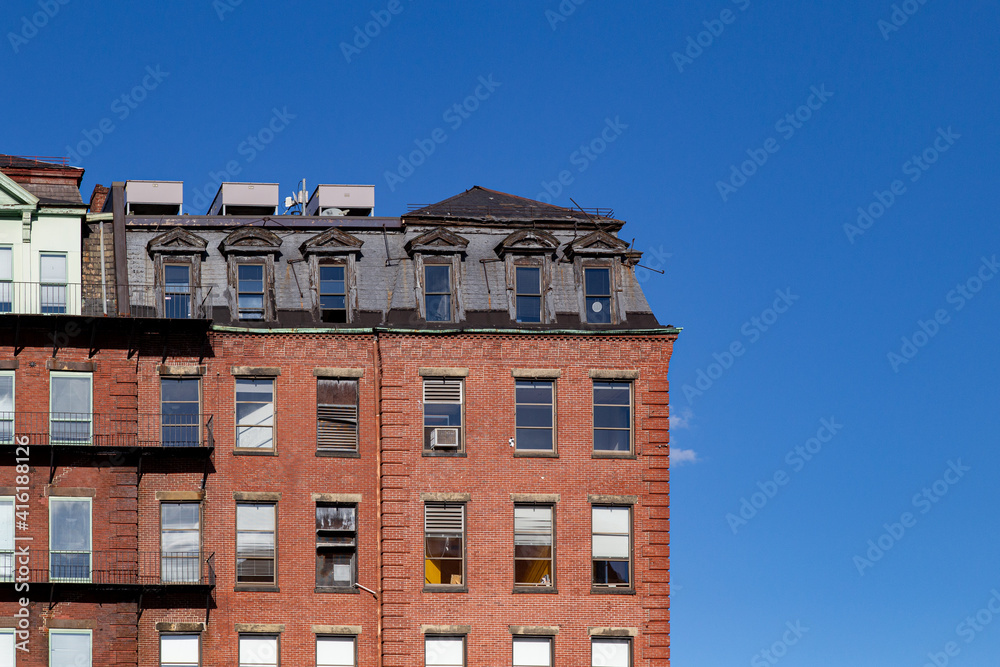 Brick apartment building with blue sky