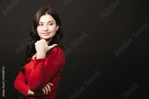 Woman with welcoming gesture on black background © Vadym