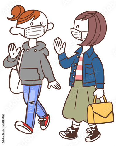 マスクを着用して会話しながら歩く若い女性たち
