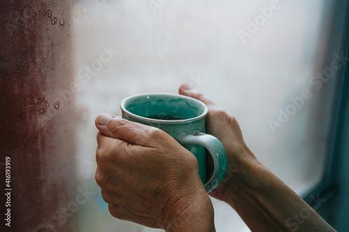 Two old hands grabbing a fast tea during a cold dayTwo old hands grabbing a fast tea during a cold day photo