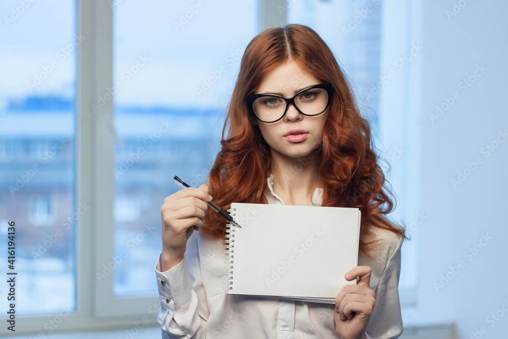 Business woman in white shirt with notebook in hands of office professionals Business woman in white shirt with notebook in hands of office professionals