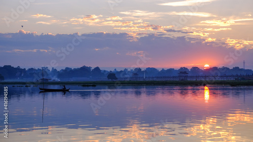 Local fishermen in Taung Tha Man lake near U Bein bridge in early morning at sunrise. Mandalay, Myanmar (Burma).