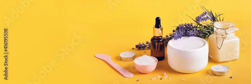 Obraz Natural cosmetics products with lavender. Home body skin care. Spa setting in neutral colors on yellow banner