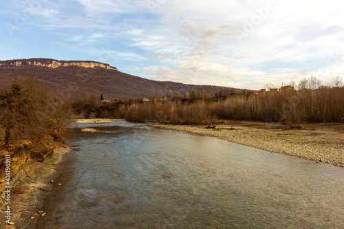 Autumn  shallow mountain river  calm flow on the plain clear water.