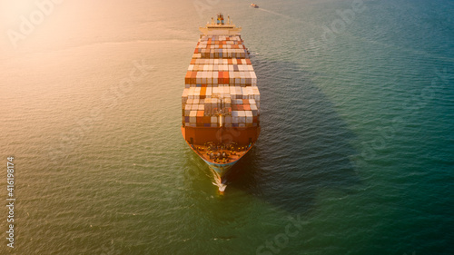  container ship sailing on the sea and over the sun light