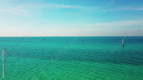 Aerial view of the sunsets over sea. Beautiful blue sea and large calm waves float on the Pacific Ocean. Ocean and sky background landscape