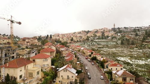 Jerusalem red rooftops in the snow aerial view
,drone view over mevasert zion close to Jerusalem covered with snow, February 2021
 photo