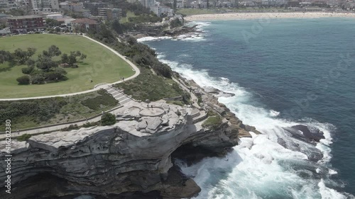 White Foamy Waves Crashing Against Rocky Inlet And Cliffs Of Mackenzies Point Peninsula - Marks Park And Coastal Walk - NSW, Australia. - aerial photo