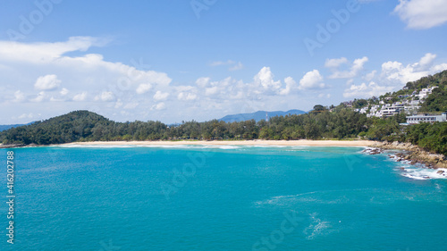 Aerial: Surin beach is a beautiful white-sand beach which is located at Phuket, Thailand © Dima