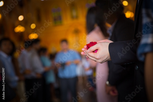 Holding flower petals at a wedding