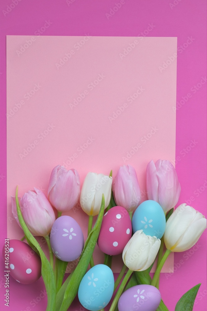 Easter holiday.Pink and white tulips flowers and blue Easter decorative eggs on a  pink background. Easter festive background in pastel colors. copy space.Spring Religious Holiday Symbol