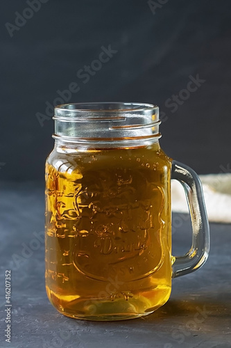 Jar of apple juice on a dark background