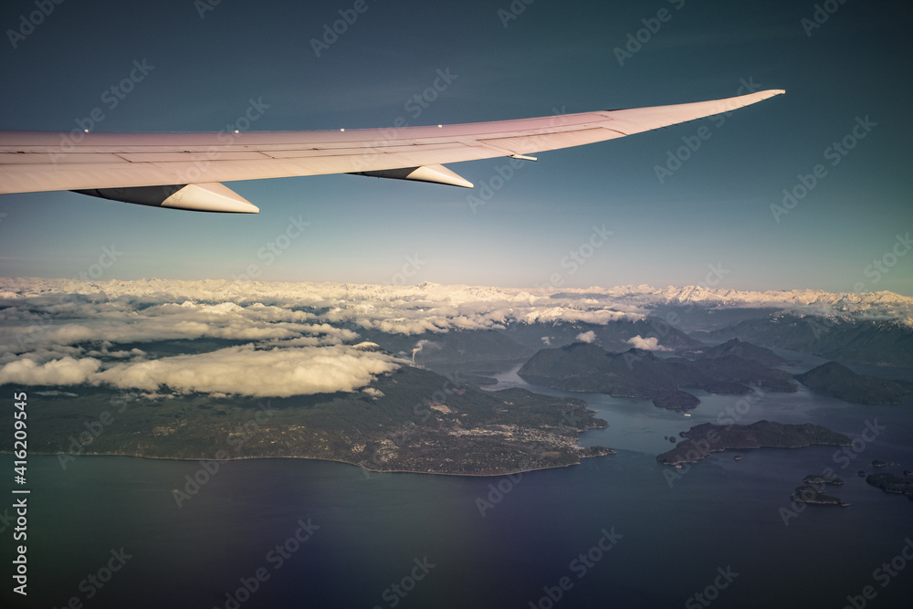 Fototapeta premium aerial view of clouds and snow cap mountains and lakes
