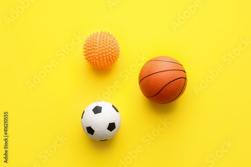 Different pet toys on color background