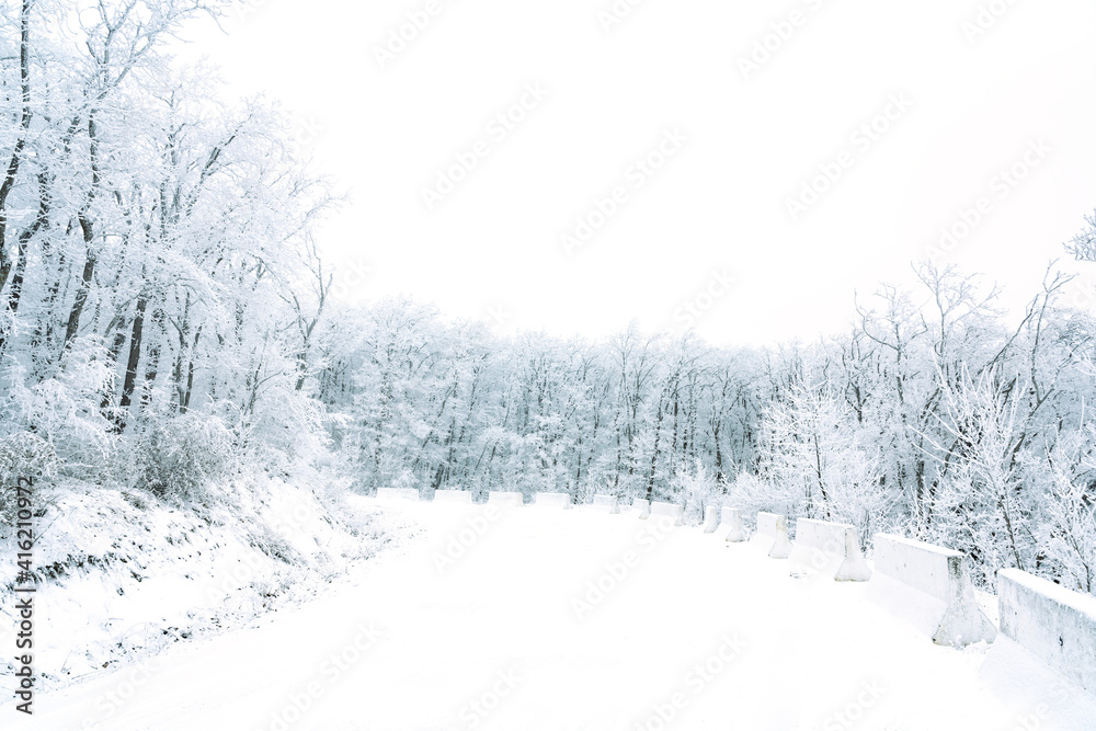 Snowy mountain road in winter forest Snowy mountain road in winter forest