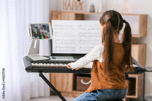Little girl studying music ...