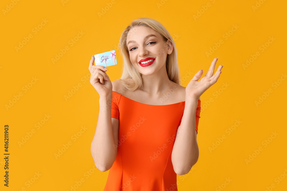 Beautiful young woman with gift card on color background Beautiful young woman with gift card on color background