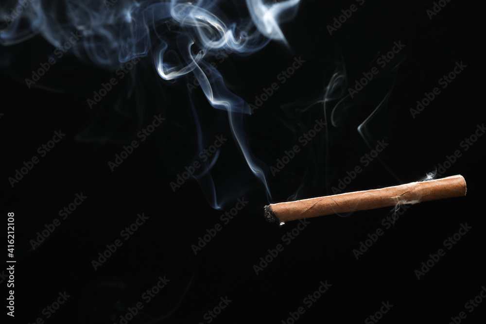 Cigarette with smoke on dark background Cigarette with smoke on dark background