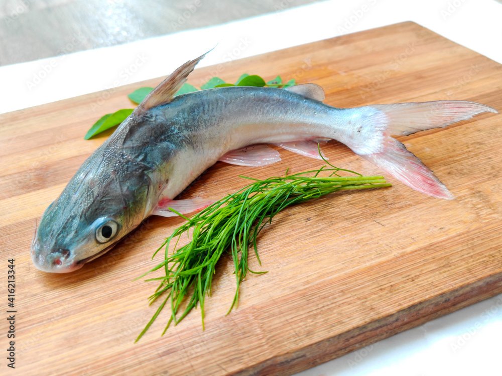 Gafftopsail Cat Fish Fish decorated with herbs and vegetables .Selective Focus. Gafftopsail Cat Fish Fish decorated with herbs and vegetables .Selective Focus.