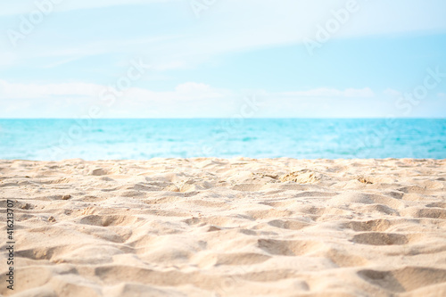 Sand beach with blue sea and blue sky blured at coast. beautiful blue ocean outdoor nature landscape background. tourist summer travel holidays concept.