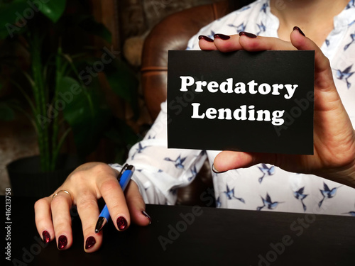 A handsome businessWoman showing a blank piece of paper with sign Predatory Lending .