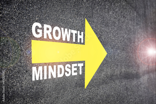 Growth mindset with yellow arrow marking on road surface. Self development to success concept and challenge idea