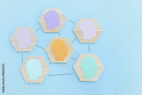 wooden blocks with people icon over blue background, building a strong team, human resources and management concept