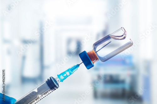 Covid-19 vaccination with vaccine bottle and syringe injection tool for coronavirus immunization treatment.