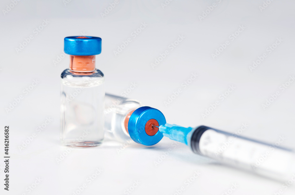 Covid-19 vaccination with vaccine bottle and syringe injection tool for coronavirus immunization treatment.