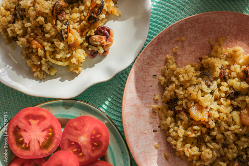 Delicious gourmet risotto with seafood, tomato and parsley
