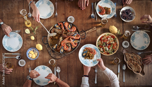 Anonymous crop people eating at table in restaurant