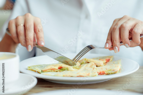 Wallpaper Mural knife and fork in the hands of a girl during breakfast Torontodigital.ca