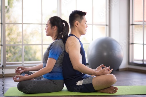 Adult asian man and woman family wearing sport outfit do exercise workout yoga for healthy self care at home