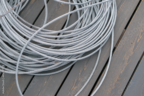 A skein of metal rope twisted wire. Dark wooden background.