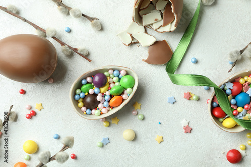 Easter concept with chocolate eggs on white textured background
